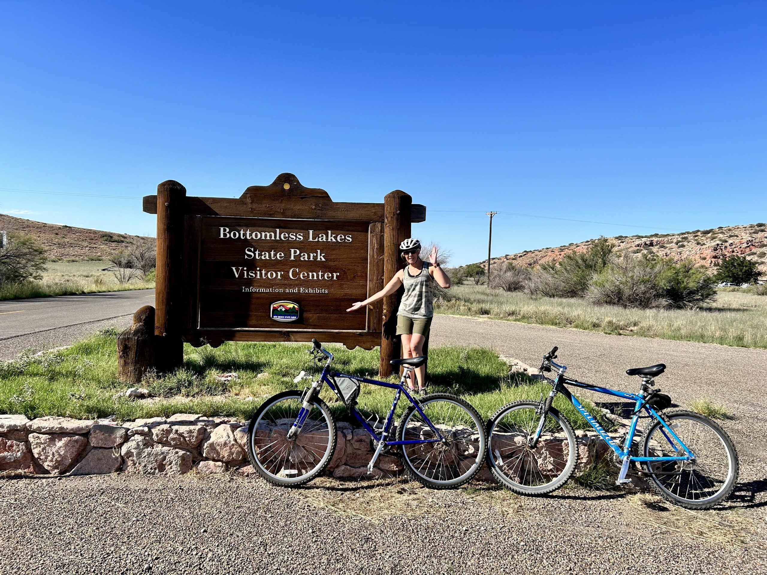 Laura posing at the Bottomless Lakes State Park entrance sign.