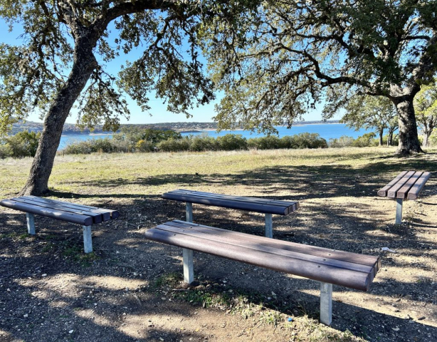 Benches under trees provide a good place to sit to look out at Canyon Lake in Texas.
