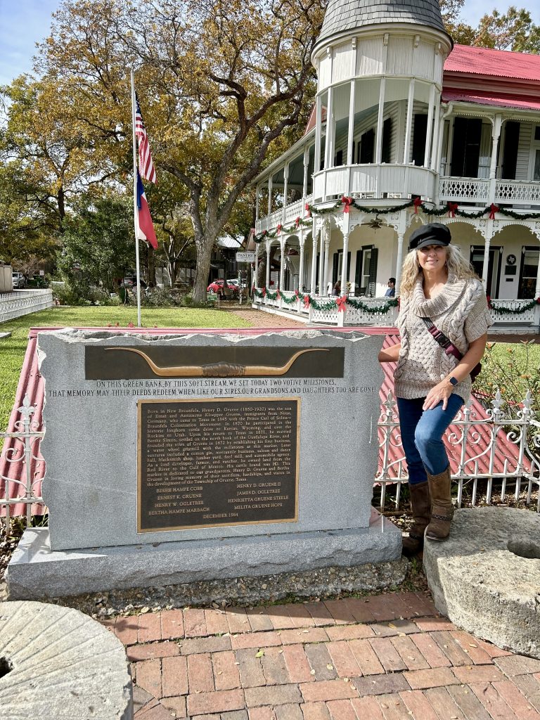 Laura at the Gruen Historic District founder sign dedicated to Henry Gruene
