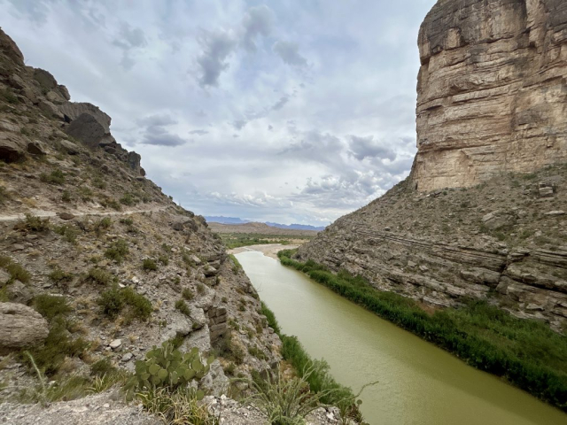 The walls of Santa Elena Canyon frame Big Bend National Park Mountains in the distance