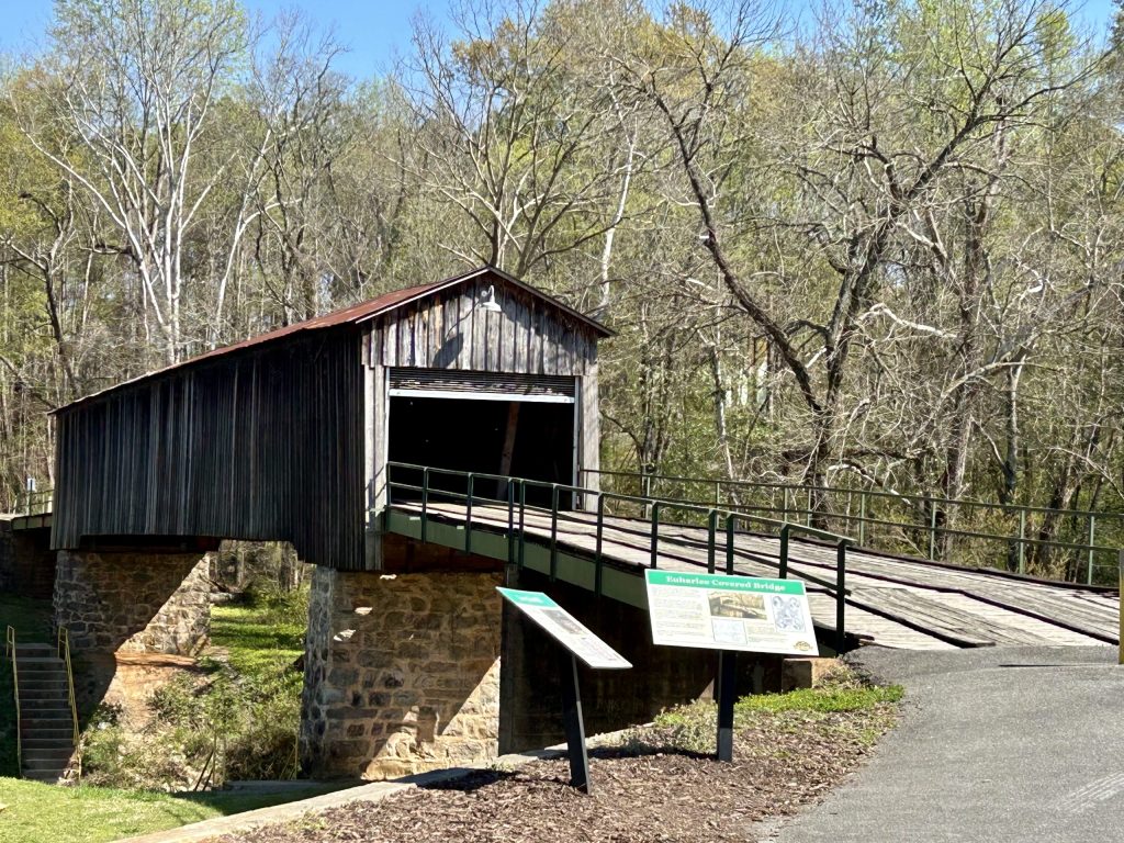 A wooden covered bridge sits over Euharlee Creek.